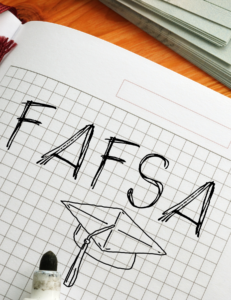 FAFSA written in notebook with grad cap drawing