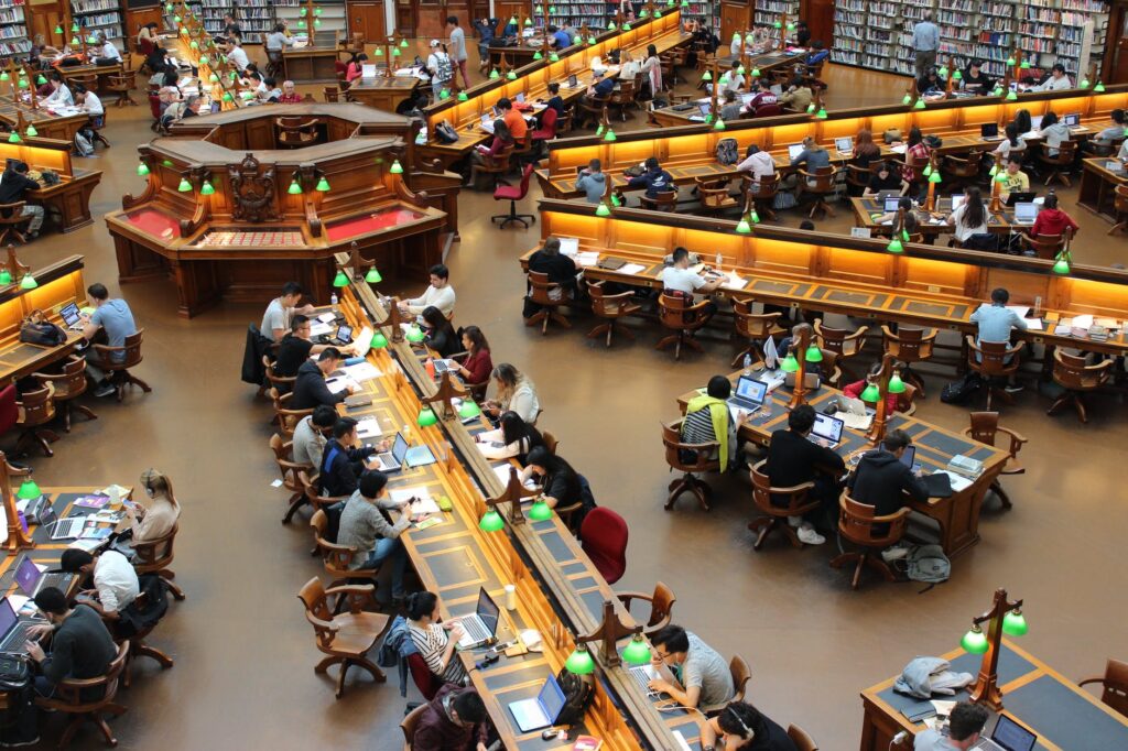 many individuals studying in an extensive library