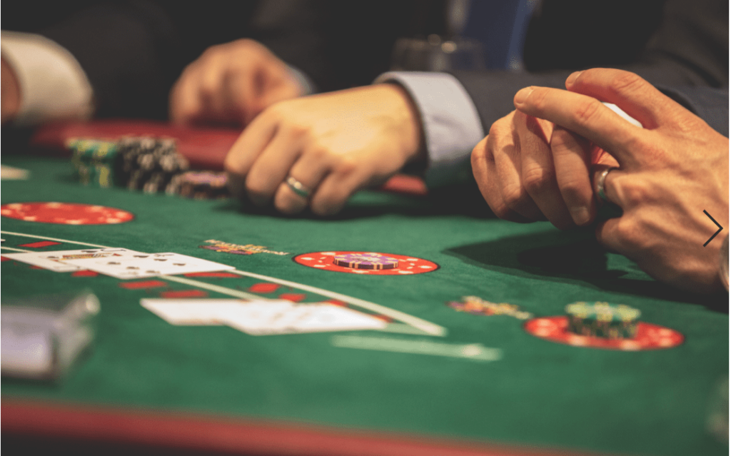three people placing bets on a blackjack table